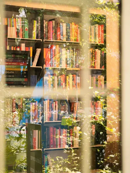 Looking through the window at our bookstore corner. I love how the light catches the spines of the books, each one holding a different world. It’s a peaceful, inviting sight that always makes me smile.