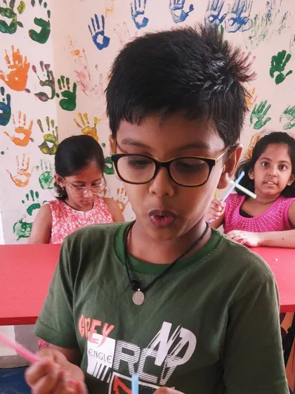 A student explains how his straw helicopter works, sharing what he learned during the crafting process.