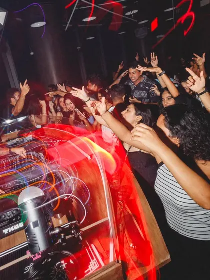 A long-exposure shot from my gig in Singapore, capturing the movement and energy of the crowd reaching for the console.