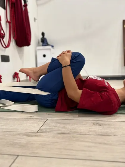 Supta Eka Pada Pavanamuktasana, or Reclining One-Legged Wind-Relieving Pose. Using a belt around the foot provides stability and helps to gently guide the knee towards the chest, releasing tension in the lower back and hip.