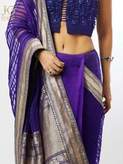 A detail shot showing the deep blue of the sapphire ring against the rich purple of the sari, a beautiful contrast of colours.
