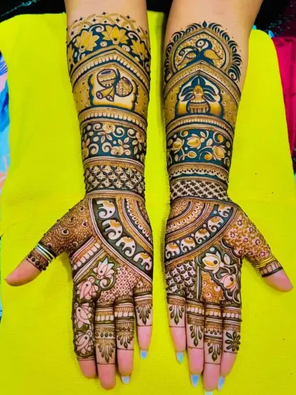 A vibrant and dense bridal mehandi with a mix of elephants, birds, and floral patterns. The rich color comes from my special blend of organic henna.