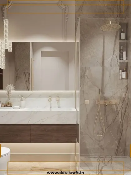 This view highlights the spacious glass-enclosed shower with gold fixtures and a built-in marble niche, blending classic materials with modern design.