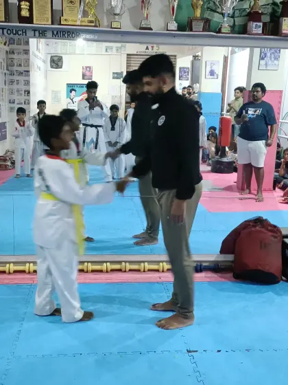 A handshake to celebrate a new yellow belt.
