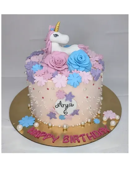 A floral unicorn cake for a 6th birthday. This eggless chocolate truffle cake is decorated with a handmade fondant unicorn surrounded by a crown of colorful flowers.