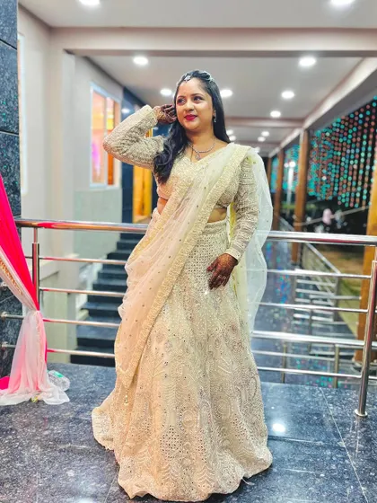 A happy client wearing a beautiful off-white chikankari lehenga. This classic, elegant style is perfect for receptions and other formal events.