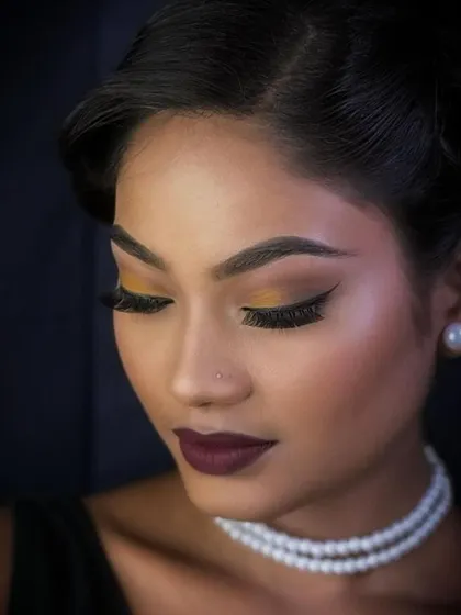 The same vintage look in color, with a focus on the warm, mustard-toned eyeshadow and deep berry lips. This shows how color theory is applied to create an authentic retro feel.
