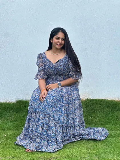 A seated pose in the blue floral dress.