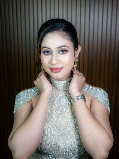 A close-up of the stunning silver-beaded gown, showing the intricate work on the high-neck, cold-shoulder blouse.