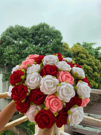 A full, vibrant bouquet of red, pink, and white roses.