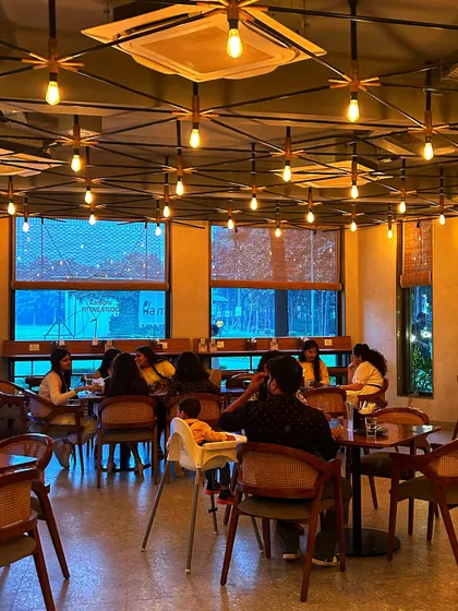 The modern interior of our cafe, featuring stylish lighting and comfortable seating for groups.