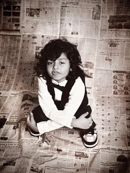 A unique high-angle shot that captures the confident and cool attitude of this young boy.