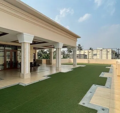 A view from the upper-level terrace, featuring an artificial turf lawn that provides a low-maintenance green space with panoramic views, perfect for entertaining.