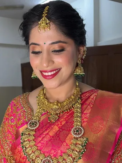 A soft, elegant pose showing the details of the eye makeup and the beautiful temple jewelry. The look is all about enhancing her natural features.