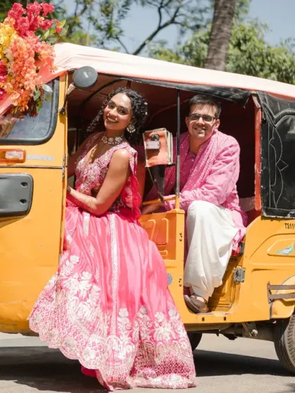 Posing in their decorated auto-rickshaw, the couple looks like stars in their own Bollywood movie. This creative shot adds a fun, cinematic flair to their haldi album.