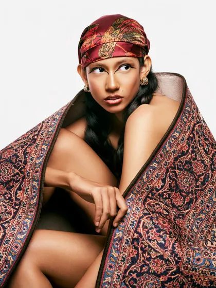 The direct gaze in this shot emphasizes the power of the graphic eyeliner. It's a look that is both a nod to tradition and a statement of modern confidence.