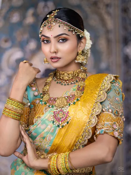 The combination of a unique saree and this stunning temple jewellery set is just perfect. The choker and haram feature intricate carvings and colourful stones.