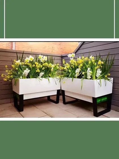 Planters on stands are a great way to create height and dimension in your garden design. These rectangular planters are elevated on simple black metal frames, giving them a modern, airy feel that works well in contemporary spaces.