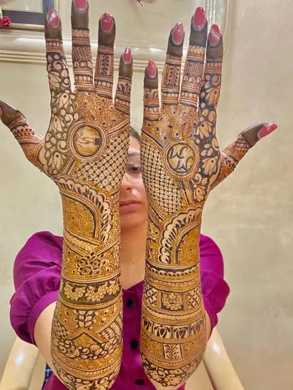 A full bridal design with initials, intricate patterns, and traditional elements. Your dream mehendi awaits.