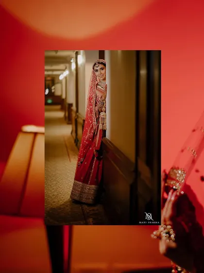A creative shot of the bride peeking out from a corner in the corridor, building anticipation.
