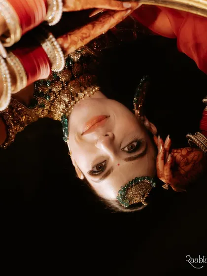 An unconventional and artistic bridal portrait, using a reflection to create an intriguing, upside-down composition.