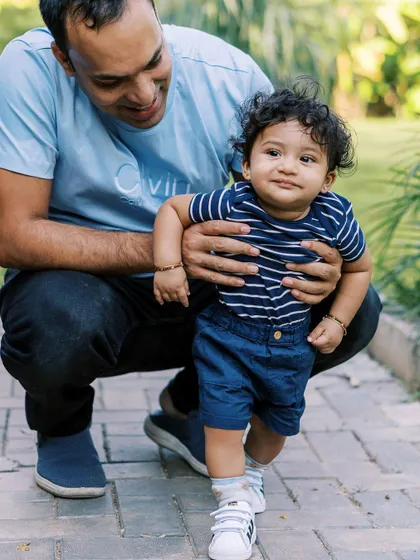 Helping a little one take his first steps is a memory worth saving. I focus on the supportive hands and the proud smiles during these fleeting milestones.