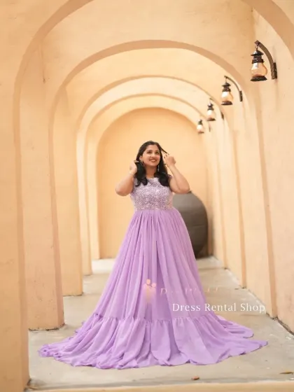 A full-length view of the lavender gown in a beautiful arched hallway, highlighting its elegant silhouette.