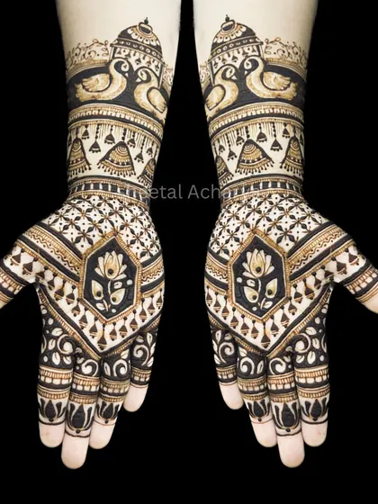 A striking symmetrical design against a black background to highlight the details. This pattern features swans, lotuses, and jhumkis, creating a perfectly balanced and royal look.