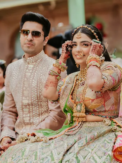 A candid moment of the bride during her Mehendi ceremony at Laxmi Niwas Palace.