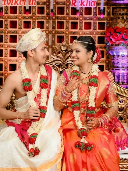 A sweet, unposed moment between the bride and groom on the wedding stage, showcasing their natural chemistry.