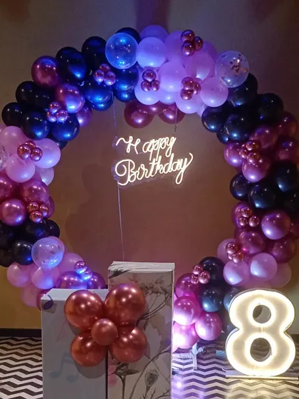This balloon ring setup is perfect for kids' parties, offering a great backdrop for photos and cake cutting.