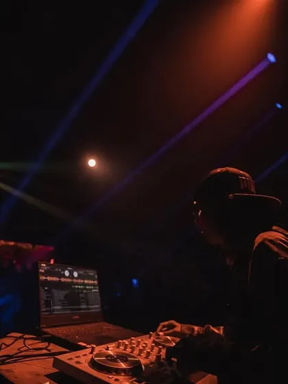 In the zone during a live show, with the stage lights cutting through the dark. This is the focus it takes to deliver a flawless set.