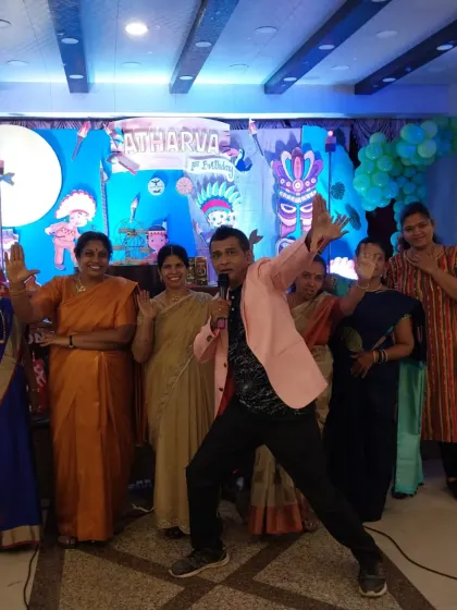 Getting the whole family involved in the fun. Here, I'm leading a group activity with the ladies at a birthday celebration, making sure adults have a great time too.