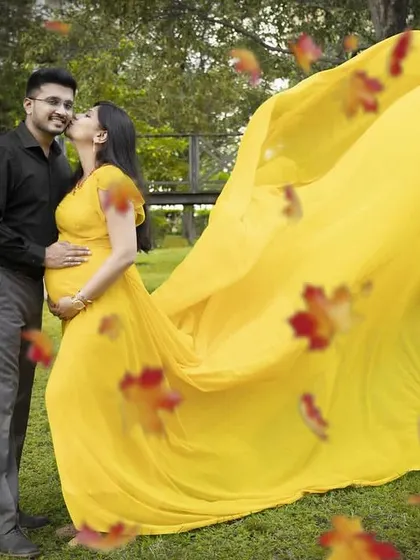 A sweet couple's maternity shoot featuring our bright yellow flying gown, which adds a pop of sunshine to the photos.