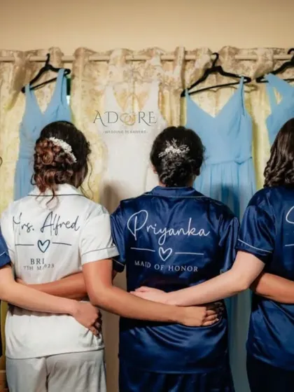 A beautiful shot of the bride and her bridesmaids from behind, showing off their custom robes. It's a perfect keepsake photo to remember the morning of the wedding.