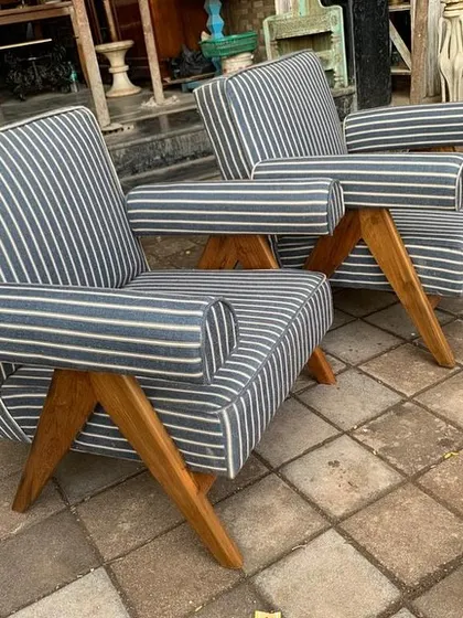 Another angle of the striped Kangaroo chairs, showcasing their unique geometric frame and relaxed seating position.