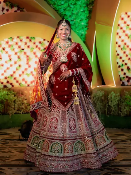 A beautiful full-length portrait of the bride, Mamta, looking stunning in her North Indian bridal lehenga.