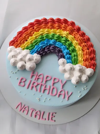 Celebrating all the colors of life with this beautiful rainbow cake. I used a piping technique to create a textured rainbow arch over a sky-blue cake.