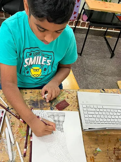 A student works on a detailed texture study using graphite pencils. Mastering shading techniques like this is essential for creating realistic and compelling drawings.