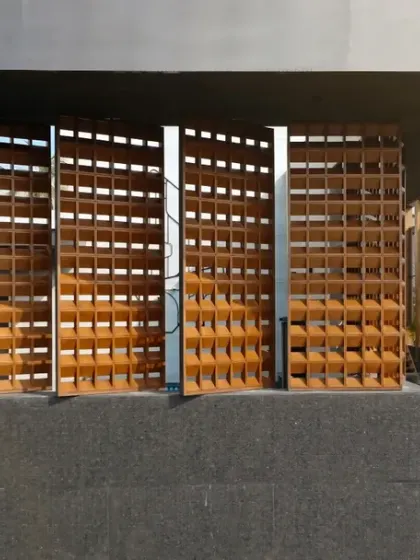 The façade of the House of Dancing Screens features these kinetic terracotta jaalis. More than just an aesthetic element, these screens pivot to control light and privacy, allowing the home to breathe and respond to the environment and the family's needs.