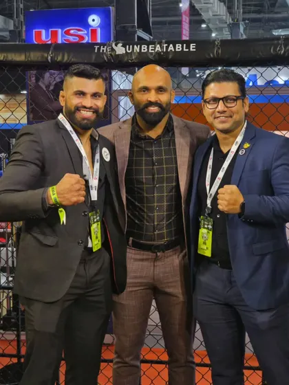 Posing for a photo with fellow officials and fighters in front of the cage. We are all working towards the same goal.
