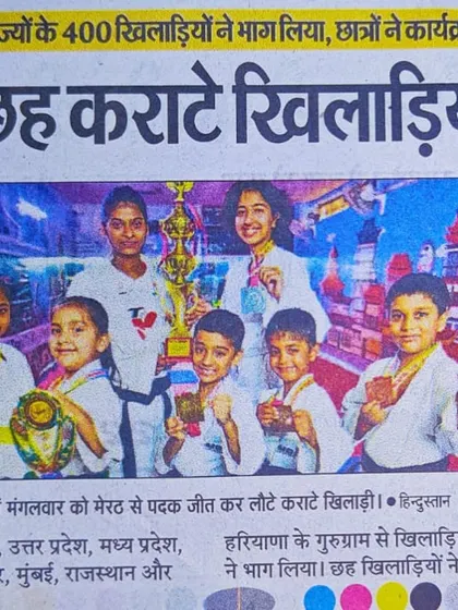 A colorful newspaper clipping showing our victorious students after their return from the Meerut championship.