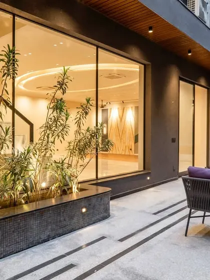 Discover minimalistic luxury in the common areas of our latest project. This cozy outdoor sitting space, complete with modern furniture and integrated planters, offers a sophisticated spot for relaxation.