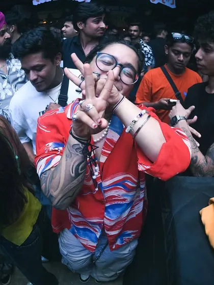 A partygoer showing peace and love. The vibe is always positive.