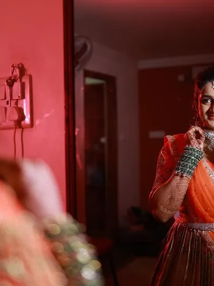 A bride checking her reflection before heading to her reception. This candid moment captures her confidence and the beautiful result of her makeover.