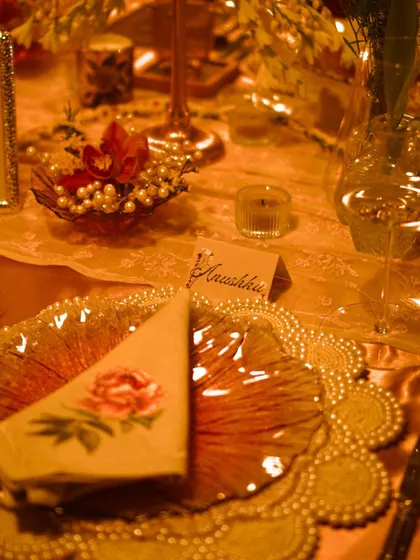 The place setting for "Anushka," the guest of honor. The floral napkin, pearl-edged charger plate, and soft candlelight all contributed to the special occasion.