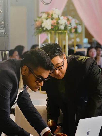 Collaborating with a guest to find the perfect track. My library is extensive, covering decades of Bollywood, Pop, and Bhangra, so I'm always ready for requests.