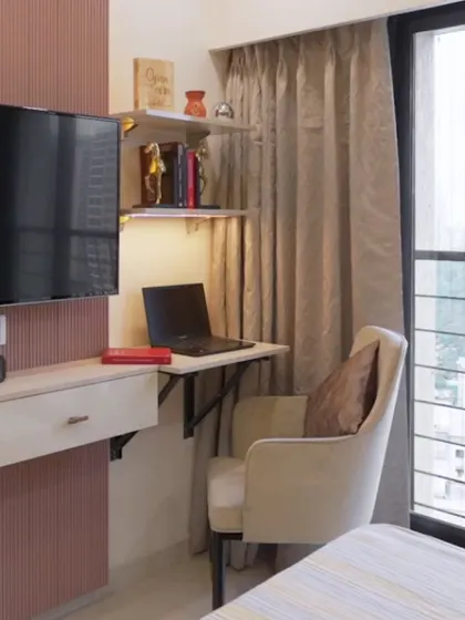 This bedroom features a compact, wall-mounted floating desk, creating a functional workspace without taking up any floor space.