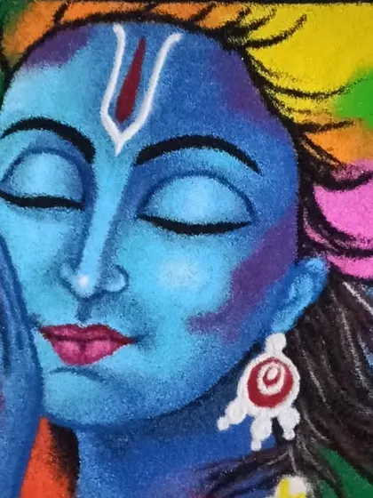 Rangoli is another medium I love. This portrait of Krishna was created using colored powders, capturing a moment of divine devotion through sand art.