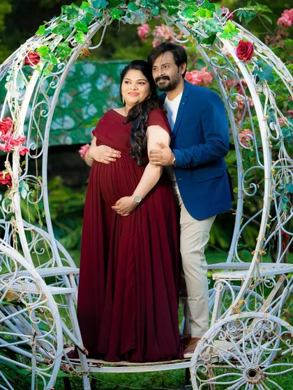 A sweet maternity moment by the Cinderella carriage, a perfect fairytale setting.